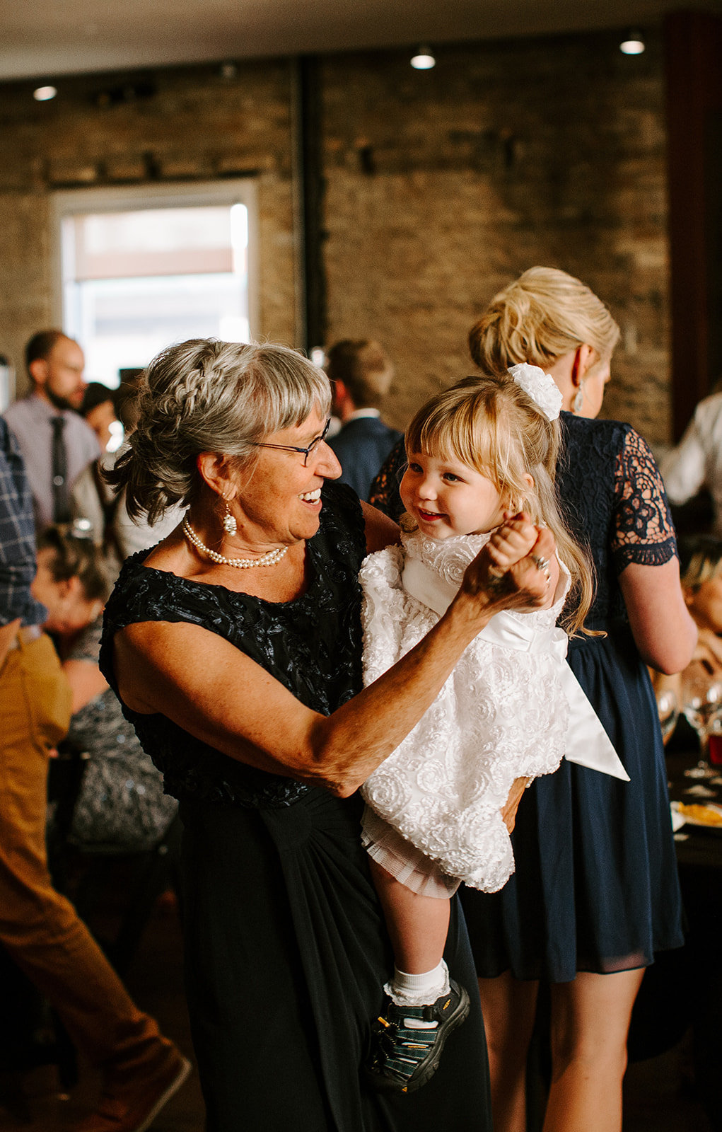 Grandmother holding her granddaughter on a Minneapolis wedding day