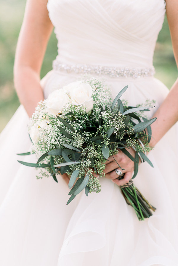 The Lodge at Ventana Canyon desert wedding photo of bride and white roses bouquet by Tucson Wedding Photographer | Bryan and Anh of West End Photography