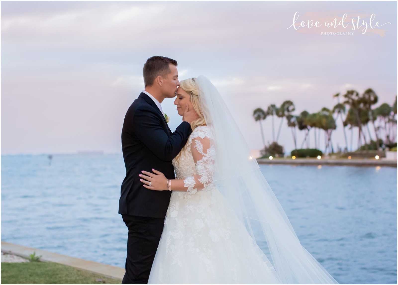 Bride and Groom embracing at the water's edge at The Ritz Carlton, Sarasota