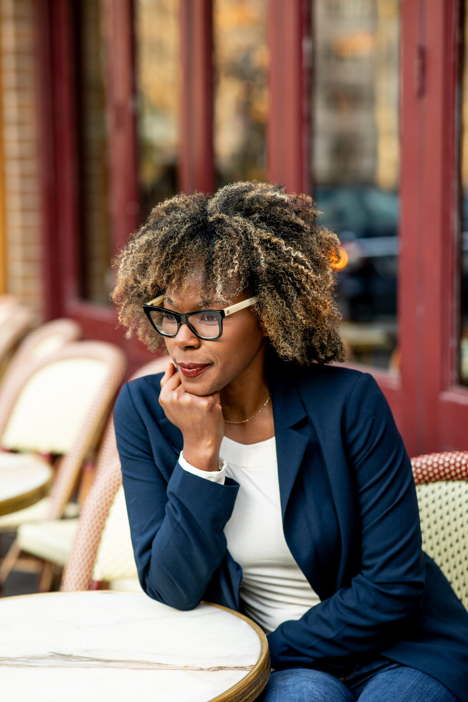 black woman with glasses at city restaurant
