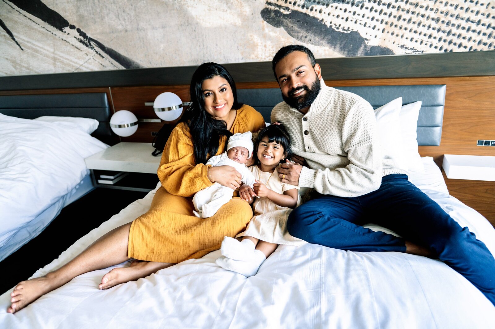 family in bed in their Maryland home with a newborn baby boy