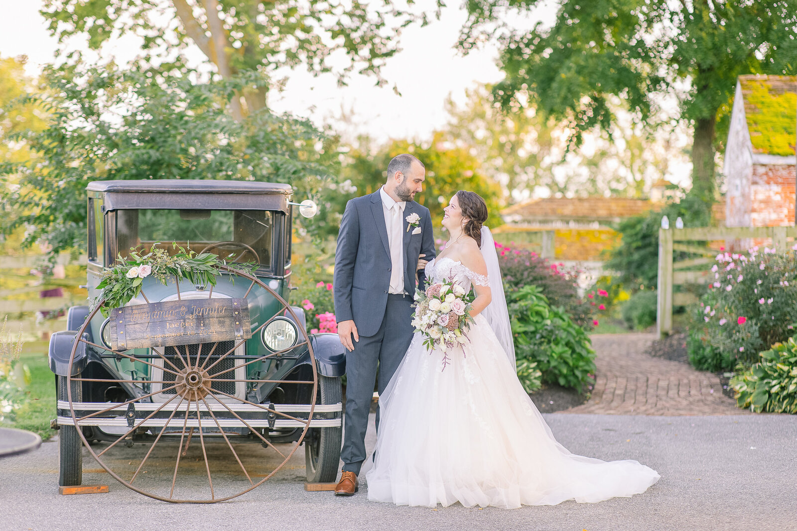 bride and groom with antique car