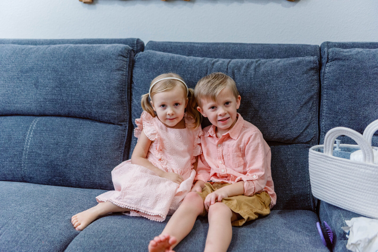 Boy and girl take a photo on the couch in their Murrieta home waiting for newborn sister