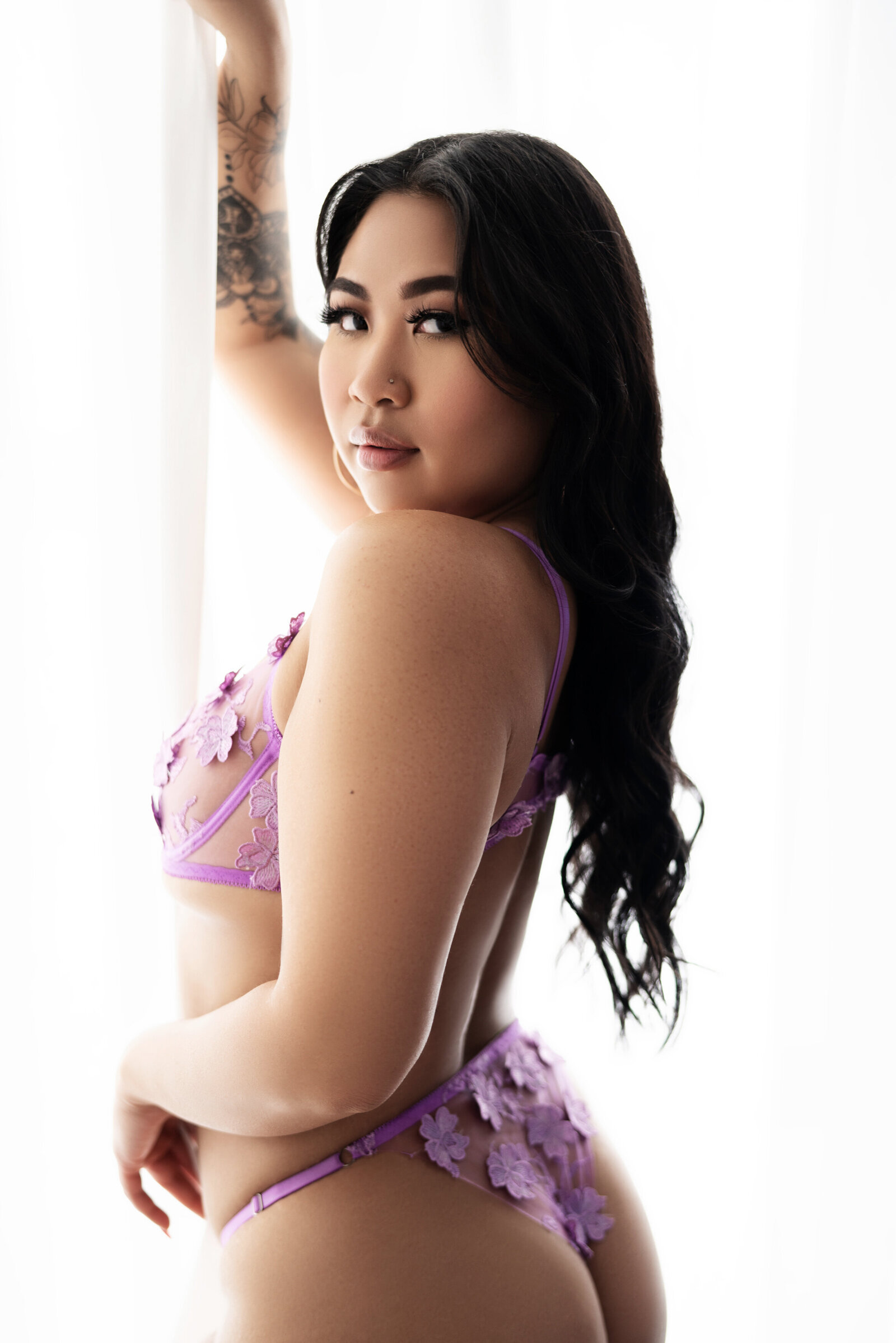 asian woman in purple flower lace lingerie at window