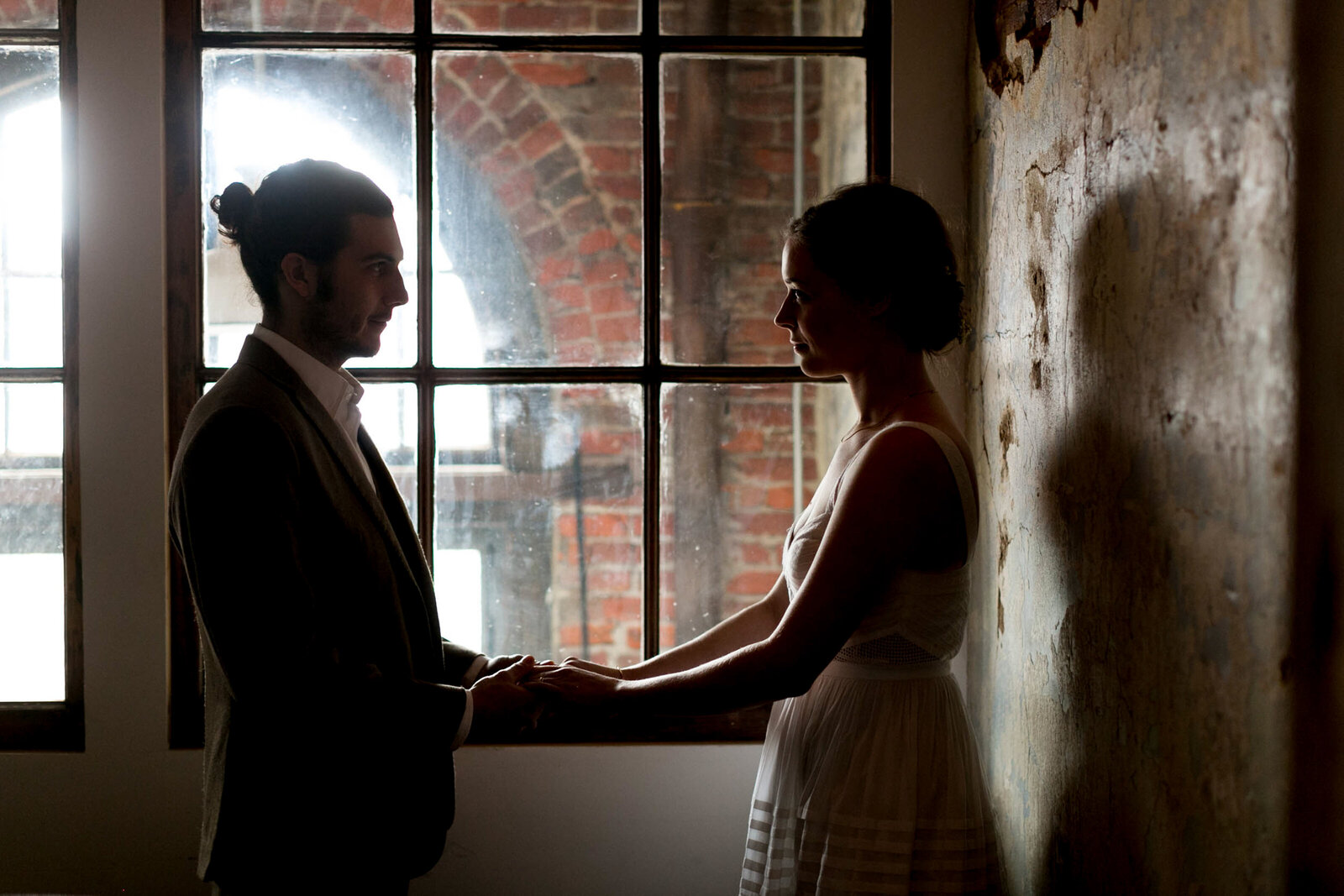 silhouette of bride and groom in window