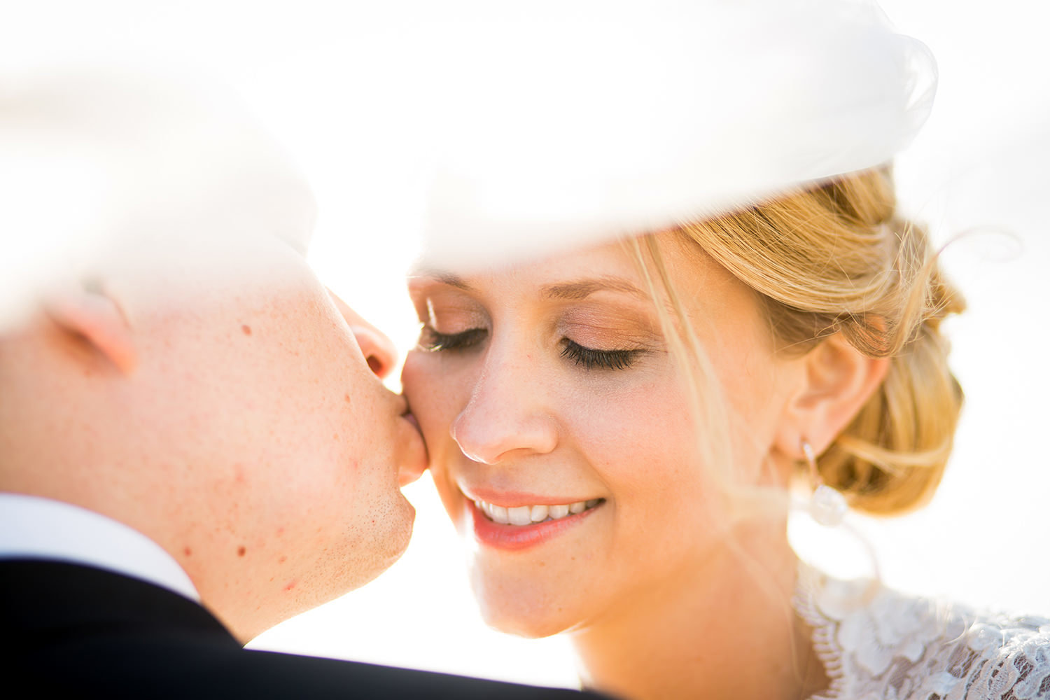 closeup of groom kissing bride