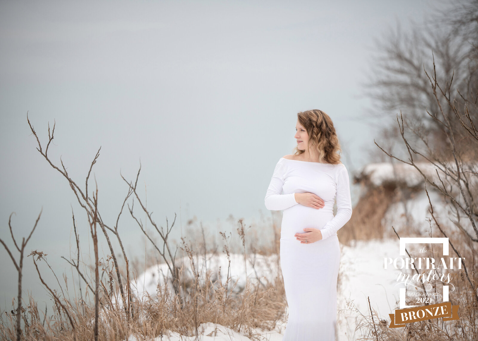 snowy maternity portrait in white Wisconsin