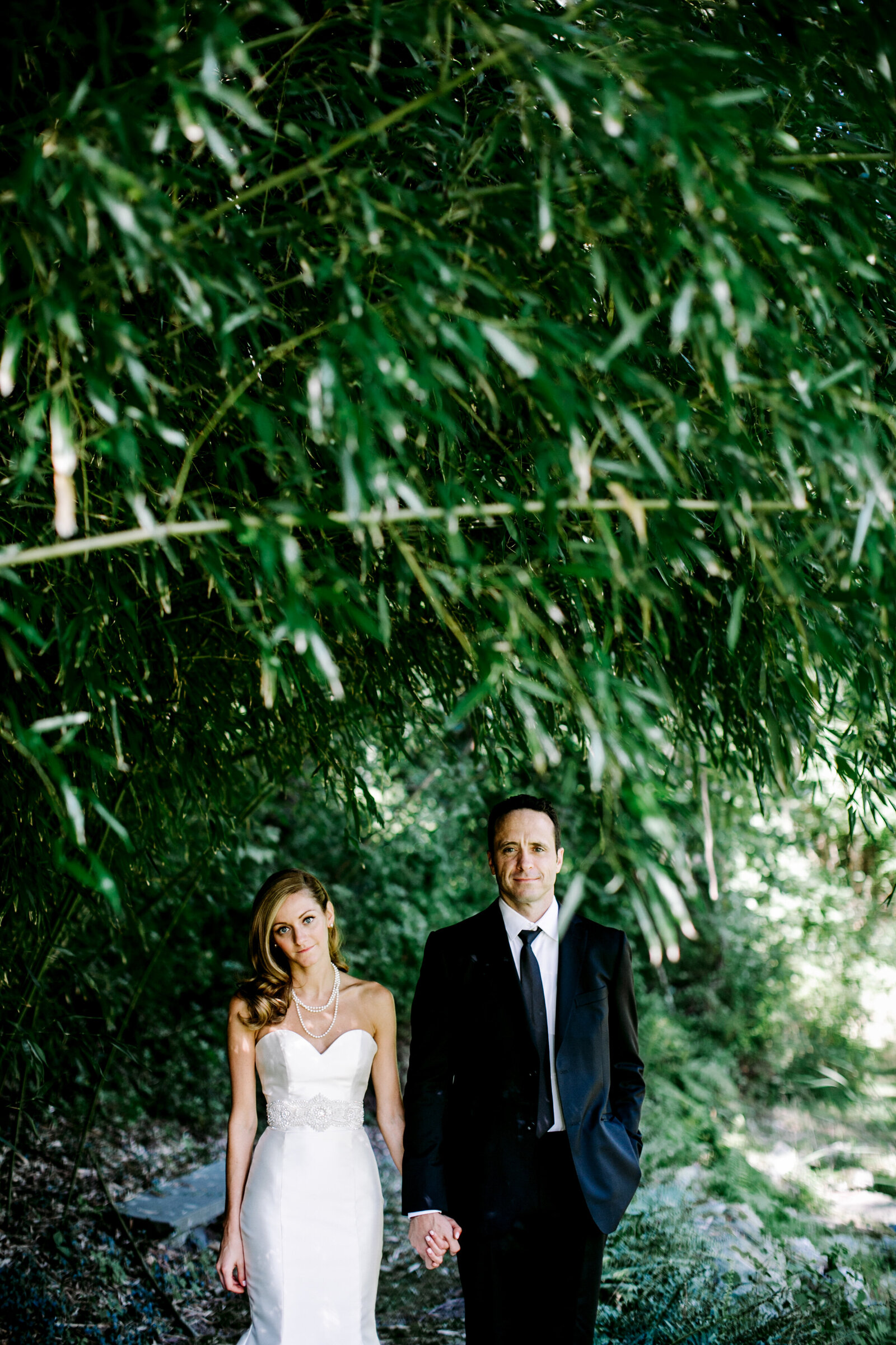 bride and groom under bamboo trees