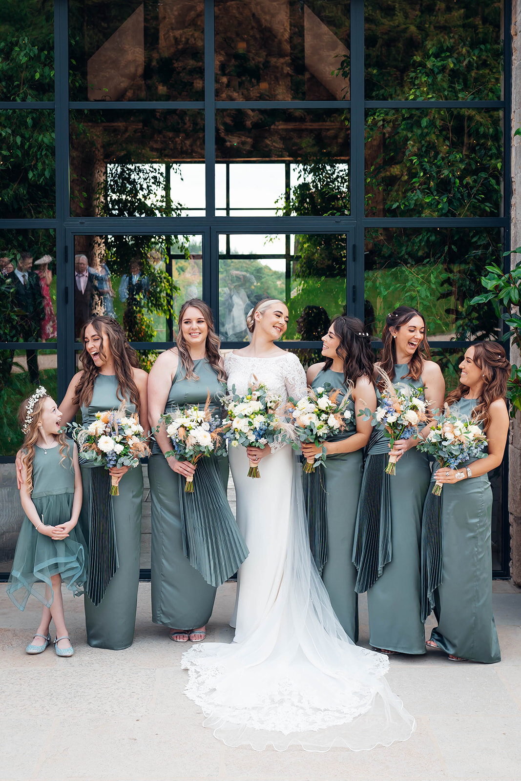 bride-bridesmaids-in-green-laughing-celebrating
