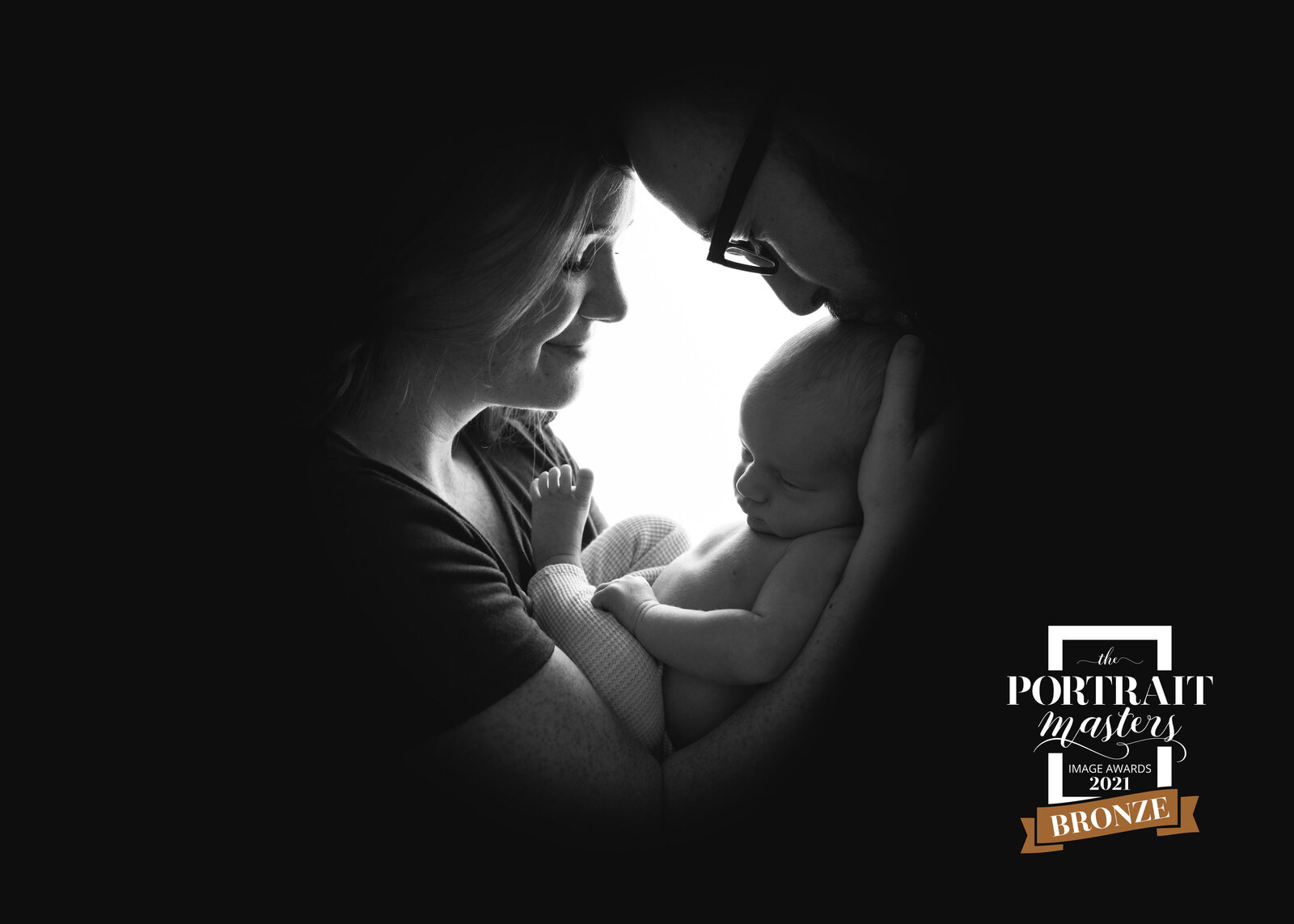black and white silhouette newborn portrait with mom and dad