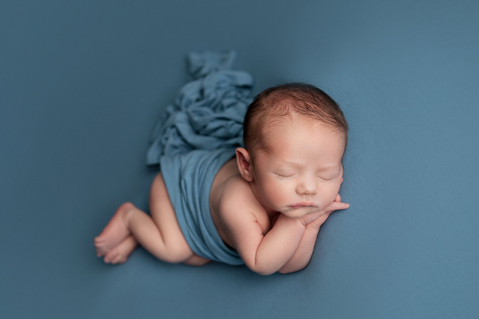 newborn and baby photography swansea blue blanket boy side laying pose