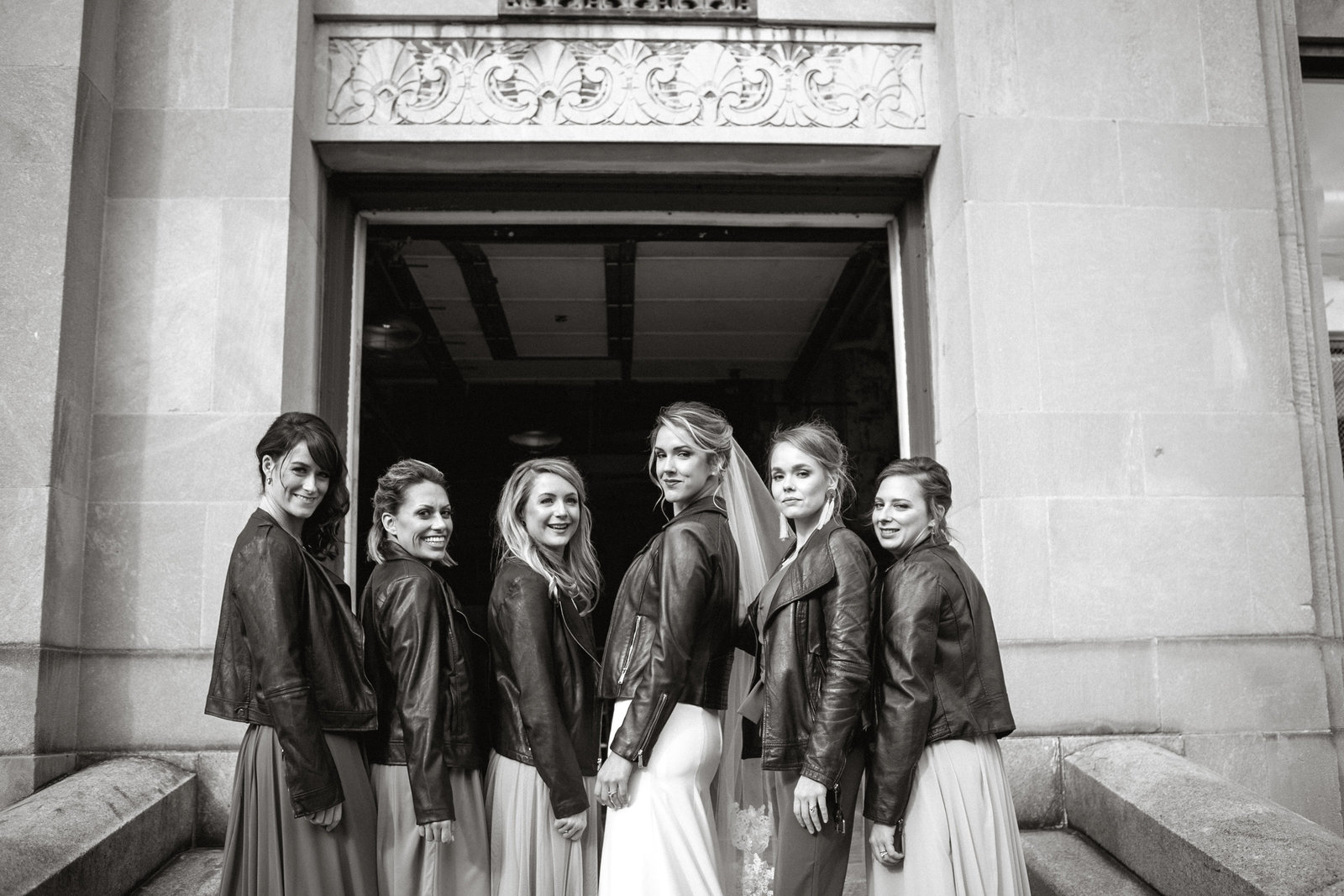 Bride and her badass bridal babes pose in coordinating leather jackets.