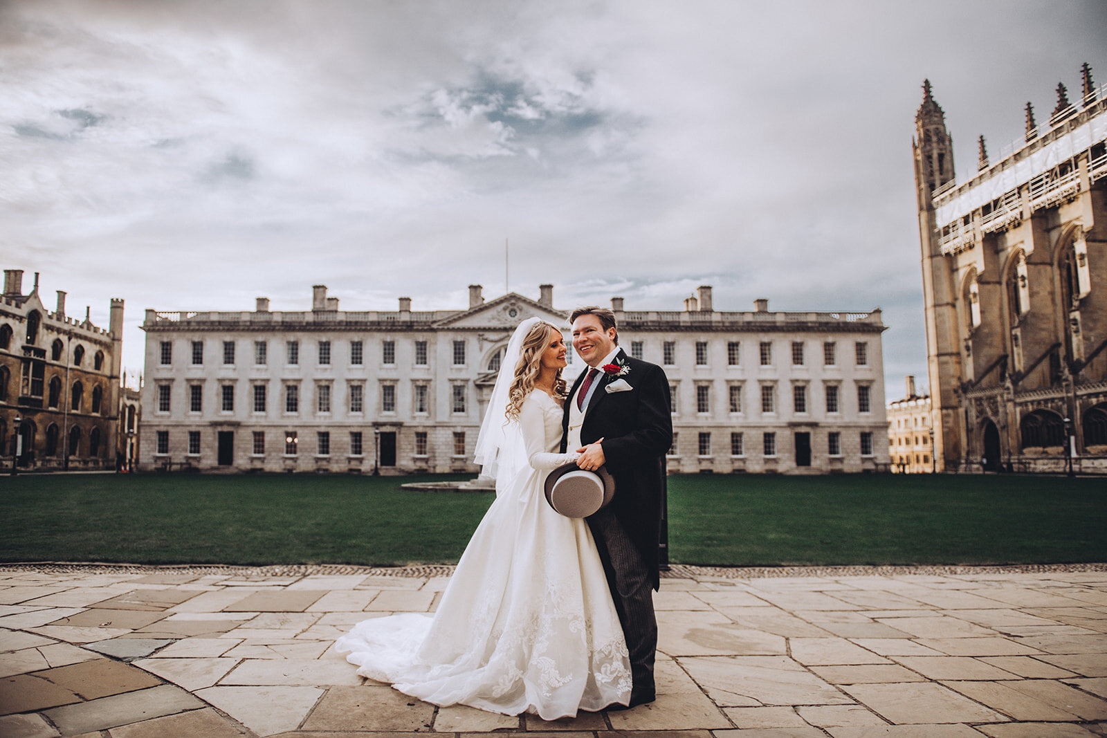 Bride and groom embracing within the grounds of Kings College Cambridge