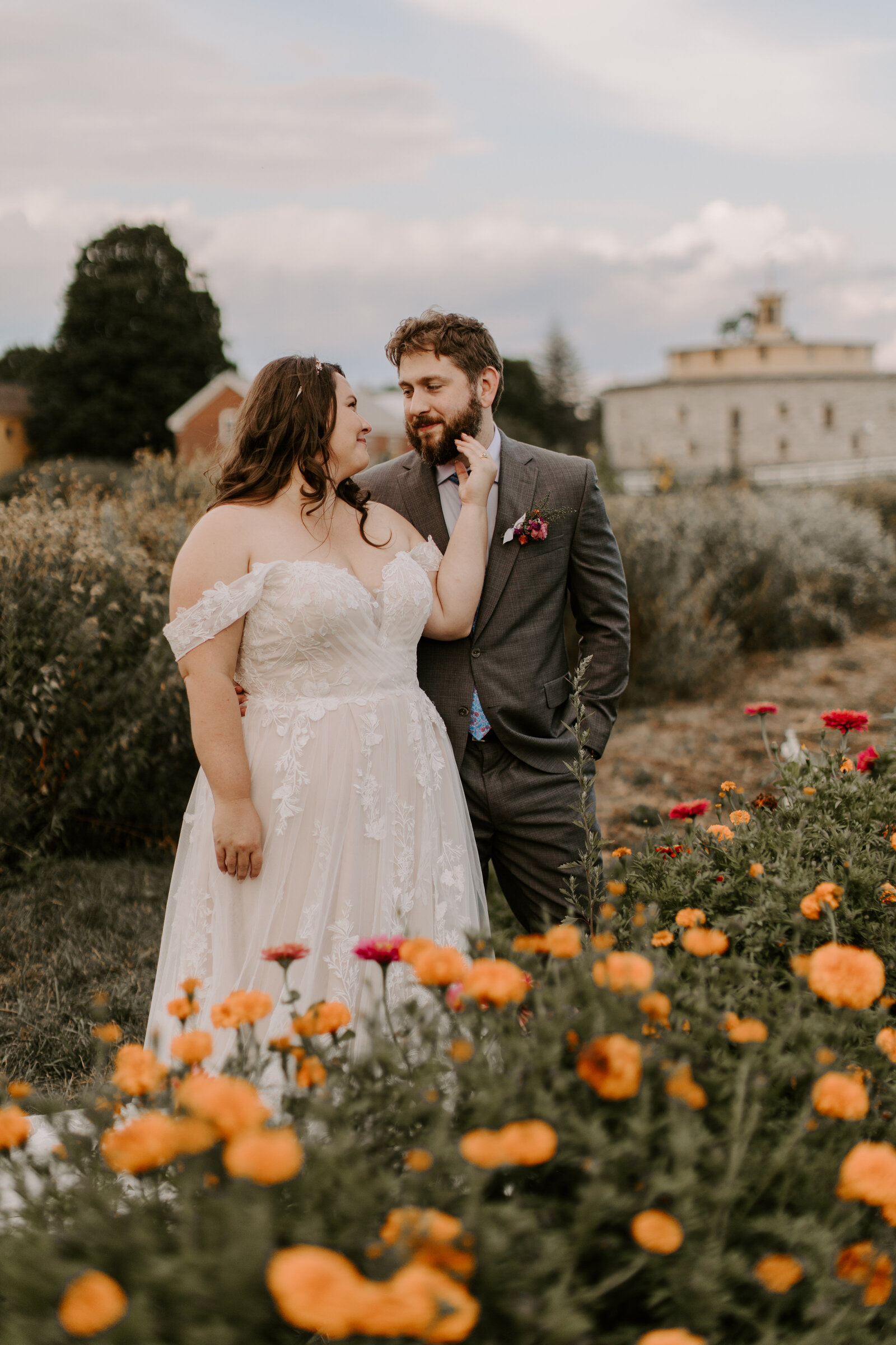 wedding couple posed in wildflower field in MA