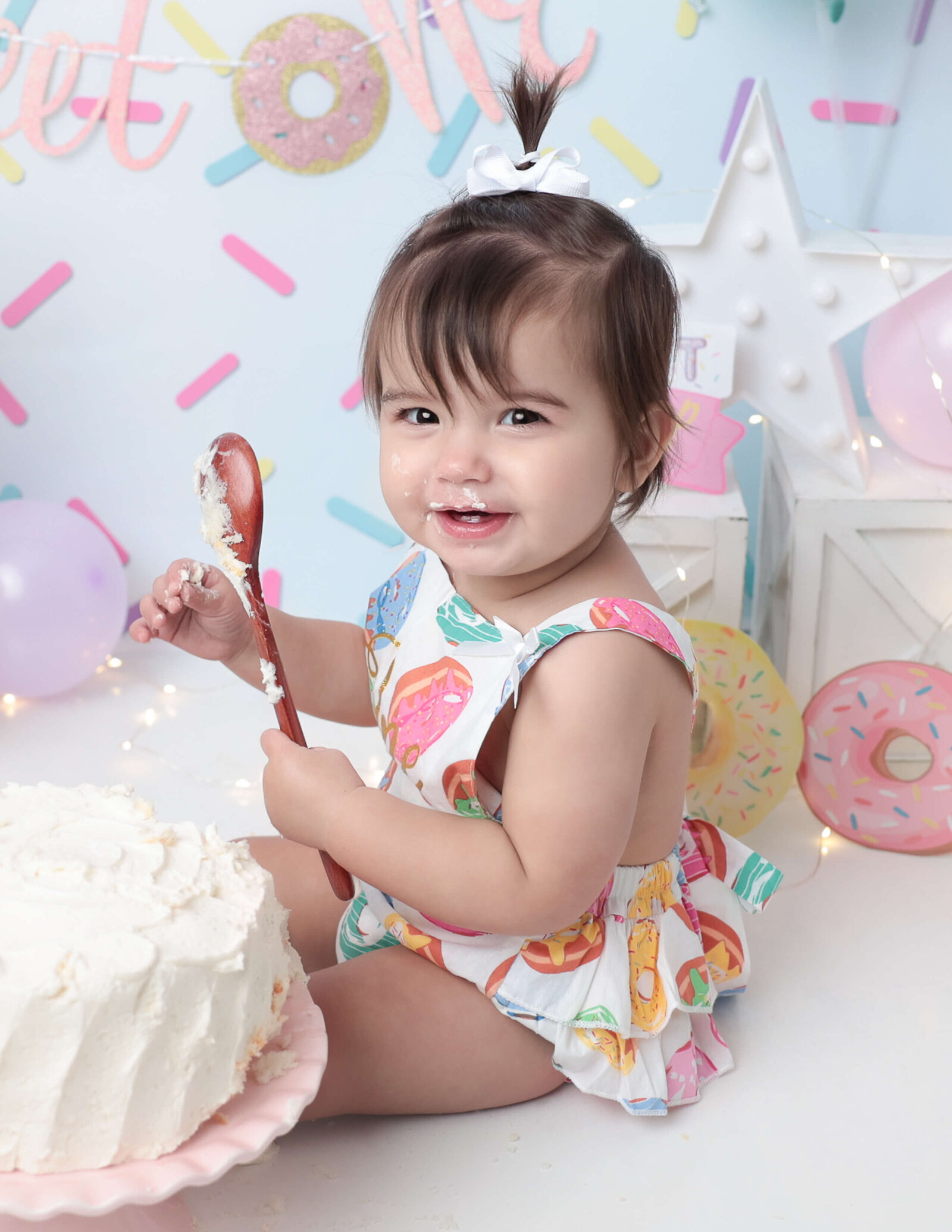 Sweet girl at  her donut themed cake smash in our Rochester, Ny studio.