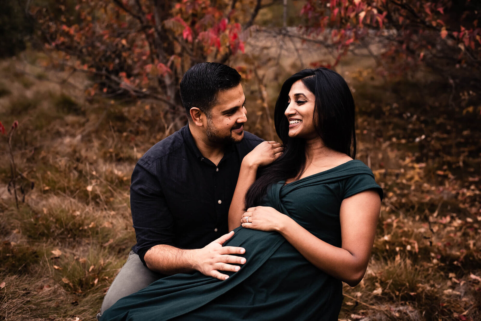 Expecting parents modelling green gown for Toronto maternity photographer