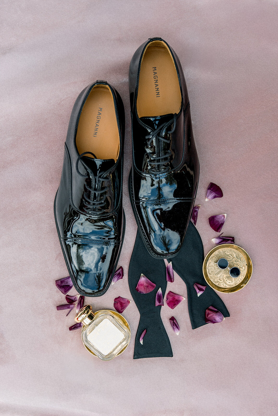 Editorial flatlay of groom’s shoes and boutonnière with elegant floral details, captured by a Los Angeles wedding photographer.