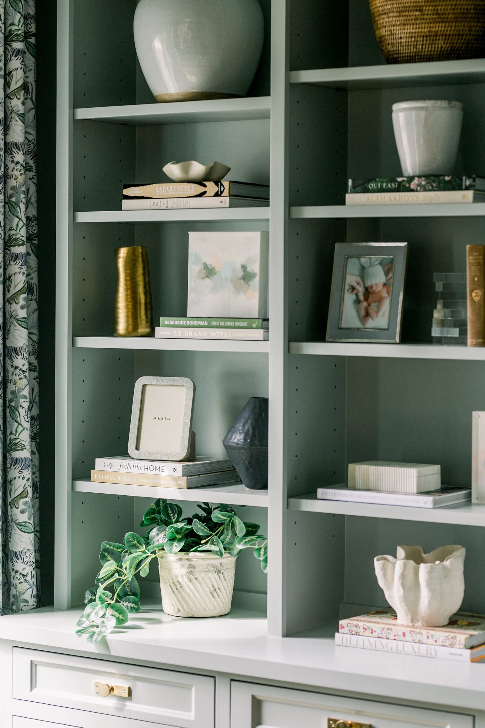 vision and hammer styling shelf with books and green plant