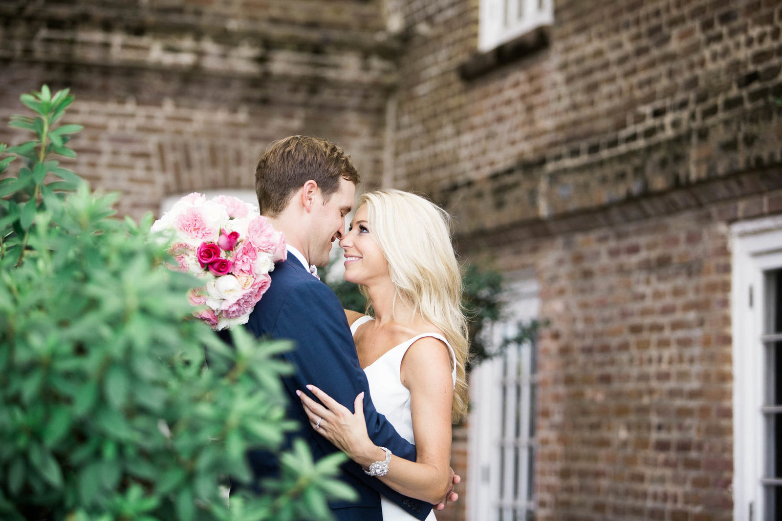 Bride and groom snuggle at the Rice Mill Building, Charleston, South Carolina