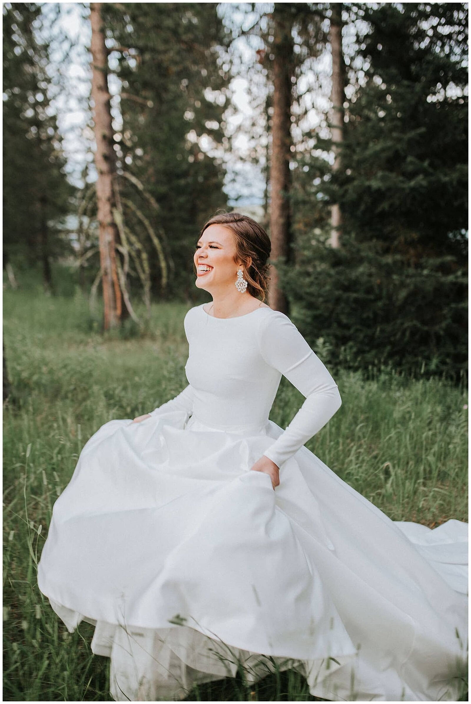 Sacramento wedding photographers capture bride carrying dress while walking through forest