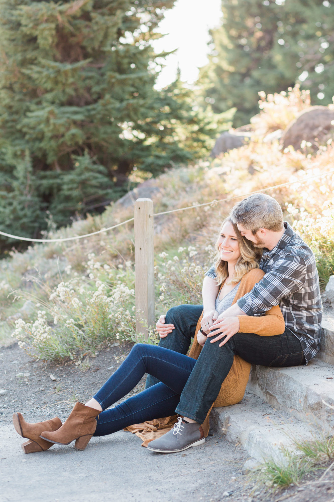 Couple sits on steps during engagement photo session