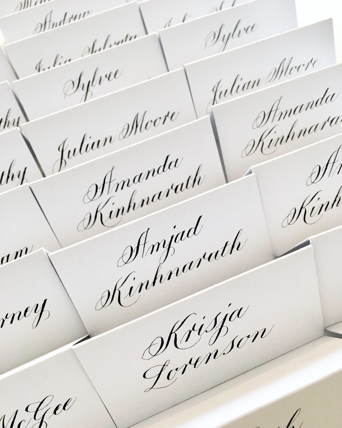Black ink Copperplate calligraphy on white place cards