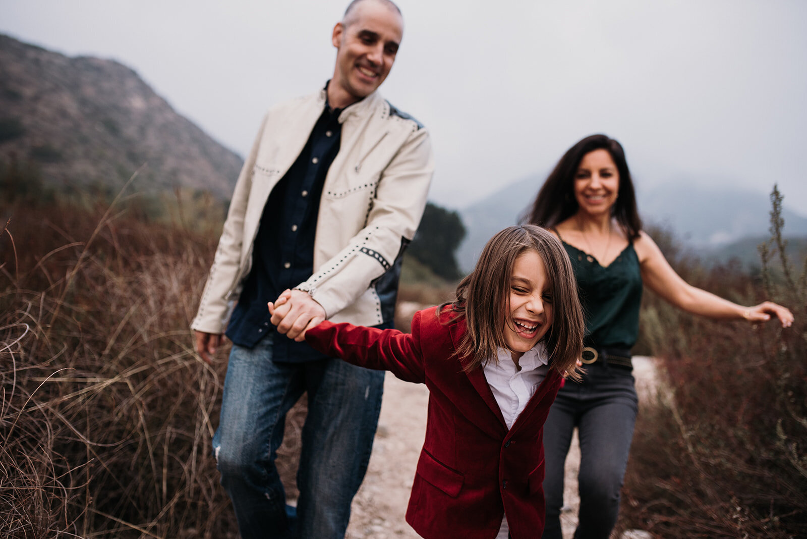 lifetyle image of child leading parents down a hill