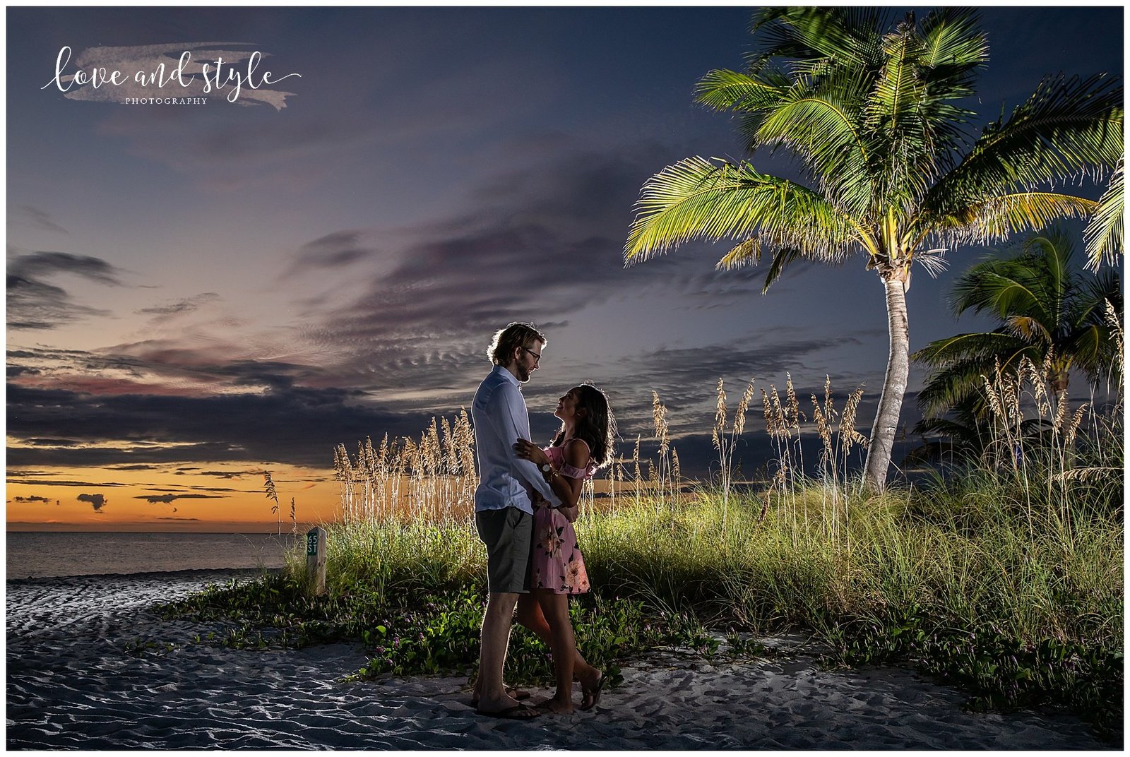 Backlit engaged couple  looking at each on Anna Maria Island