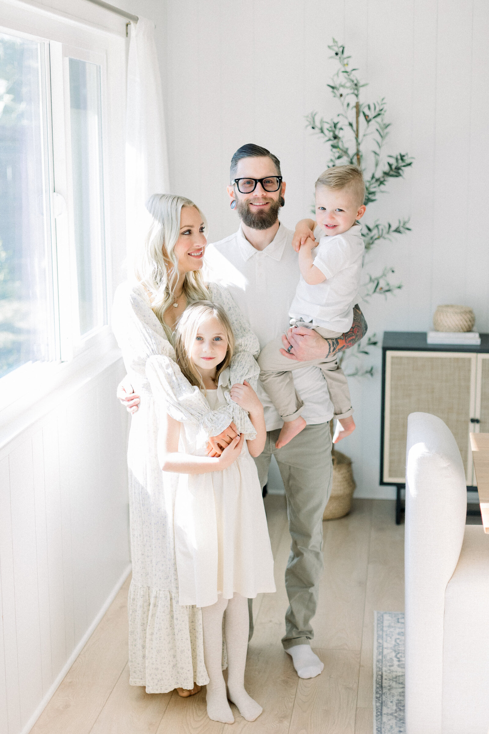 In home family portrait session of young family wearing light neutral colors taken by Family Photographer Sacramento Kelsey Krall