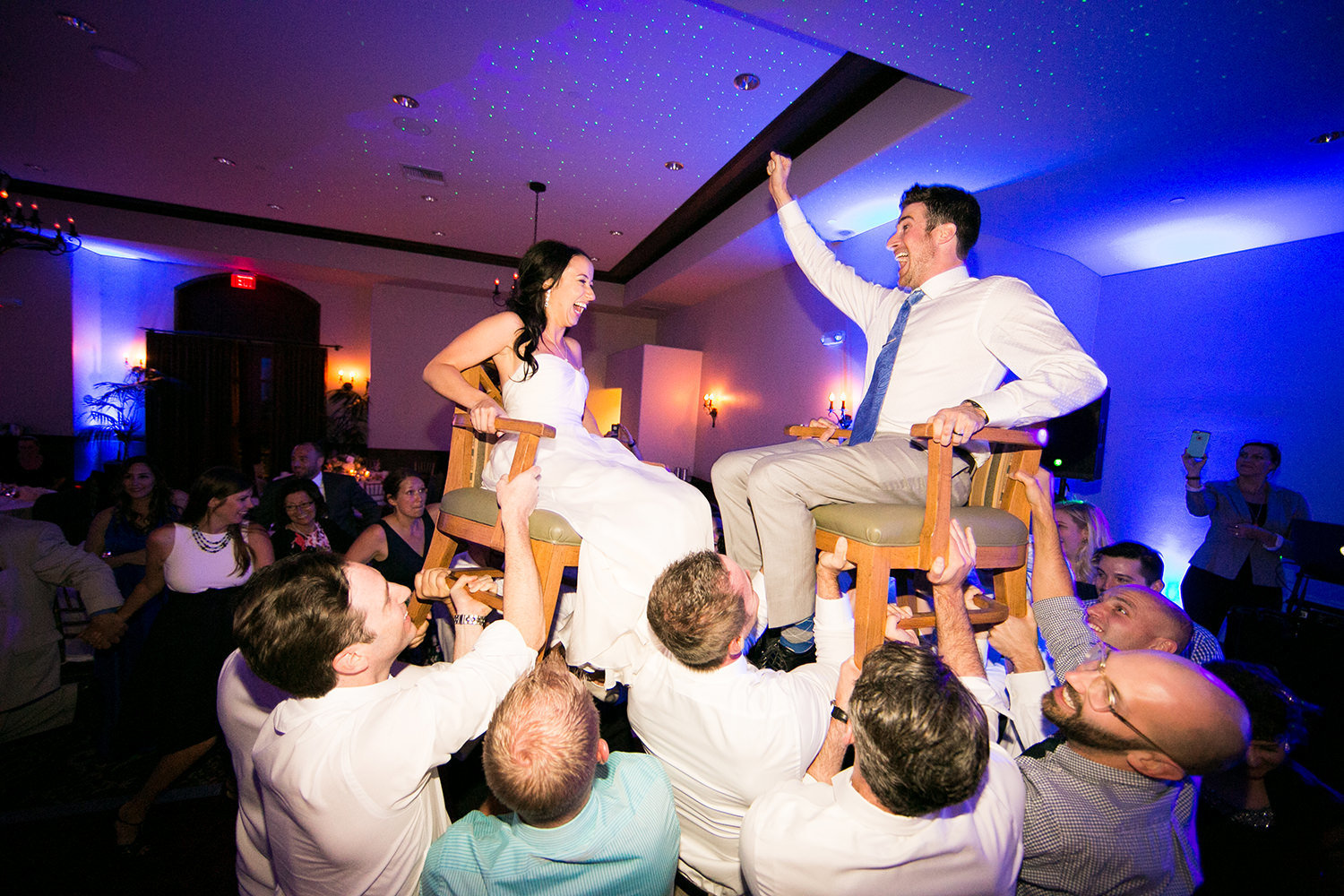 couple on chairs up in the air at reception