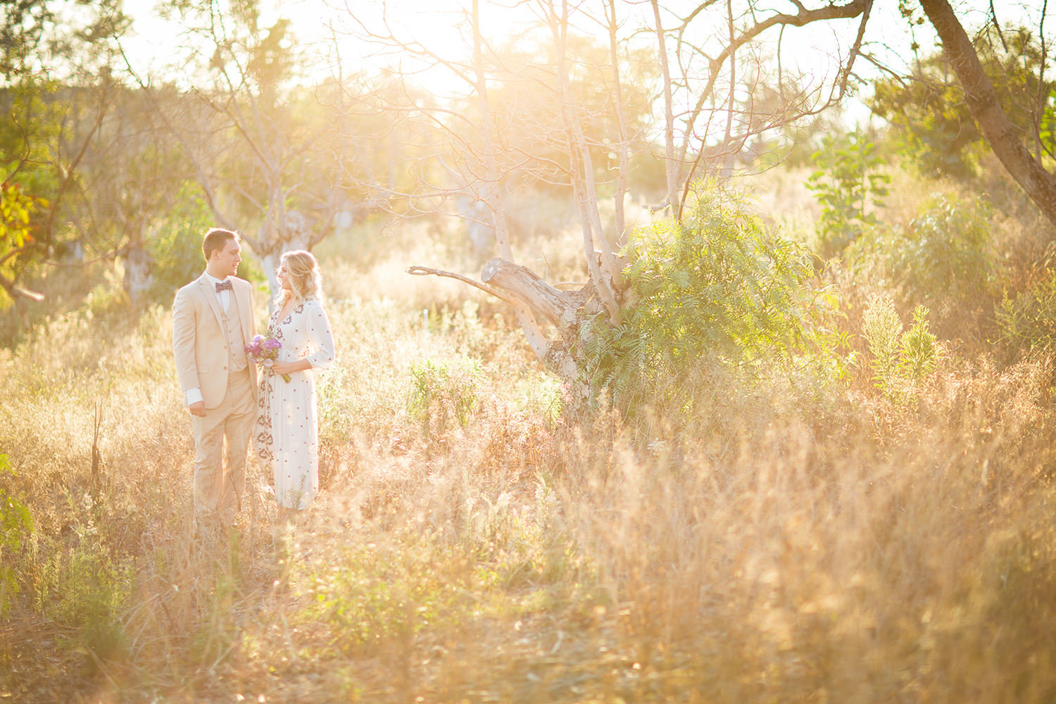 amazing light with bride and groom in open field