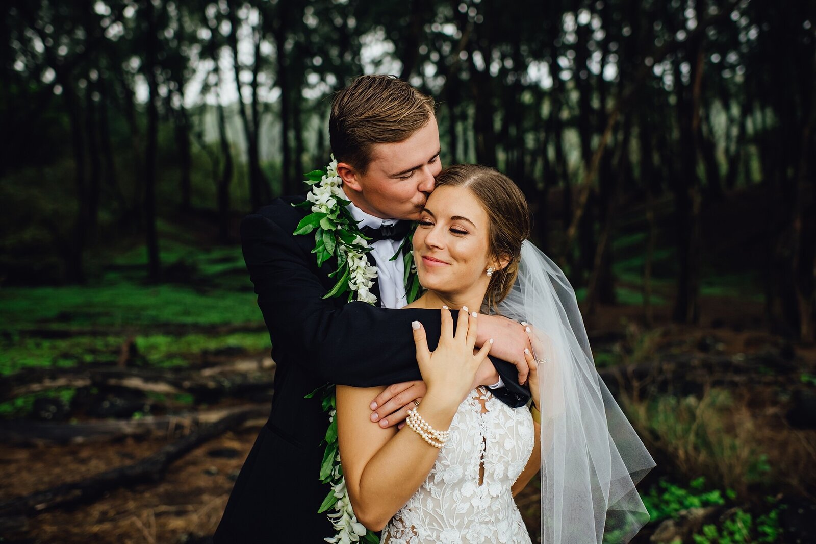groom embraces bride after their big island elopement