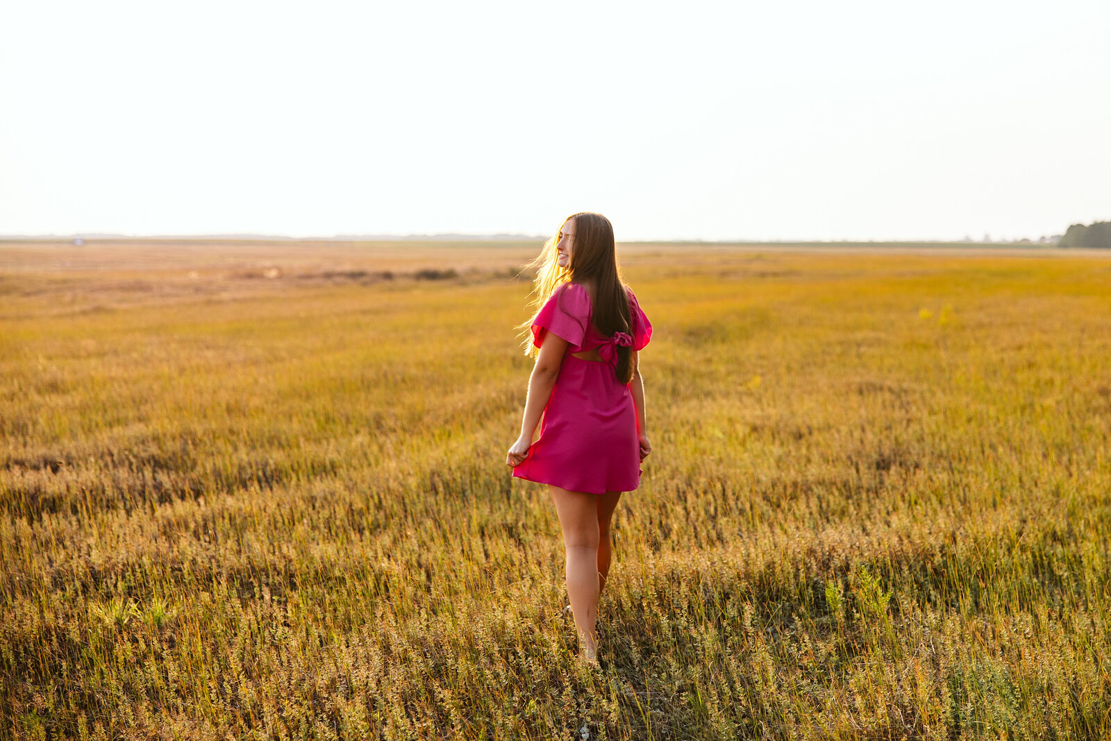 High school senior girl walking in a field - Park Rapids, Minnesota
