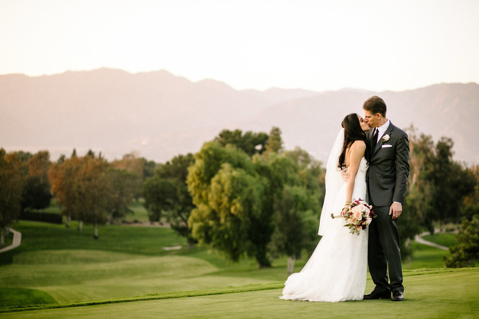 bride and groom kissing at red hill country club wedding in rancho cucamonga