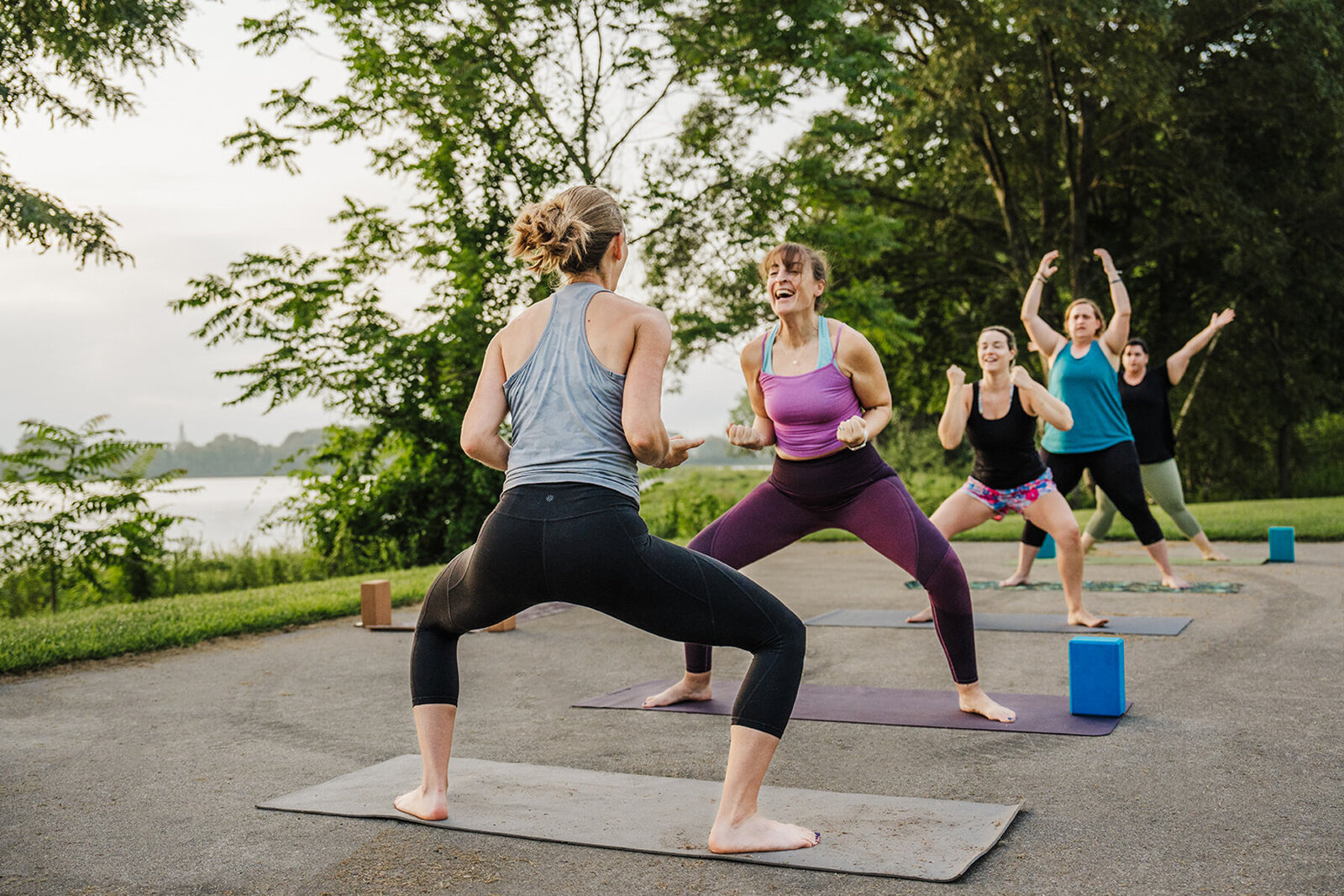 woman yells with joy during outdoor yoga class