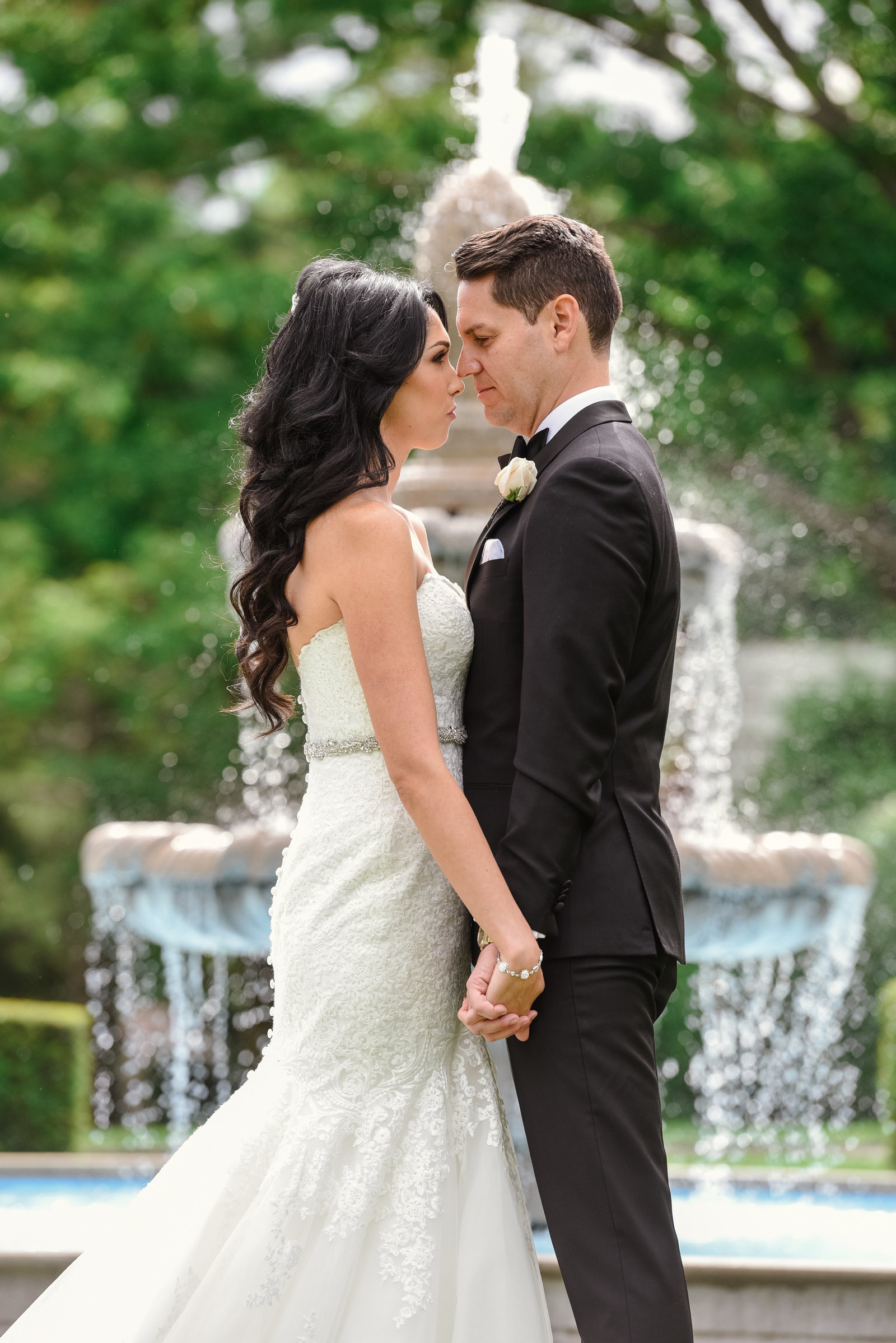 Bride and groom at the fountain of Glen Cove Mansion
