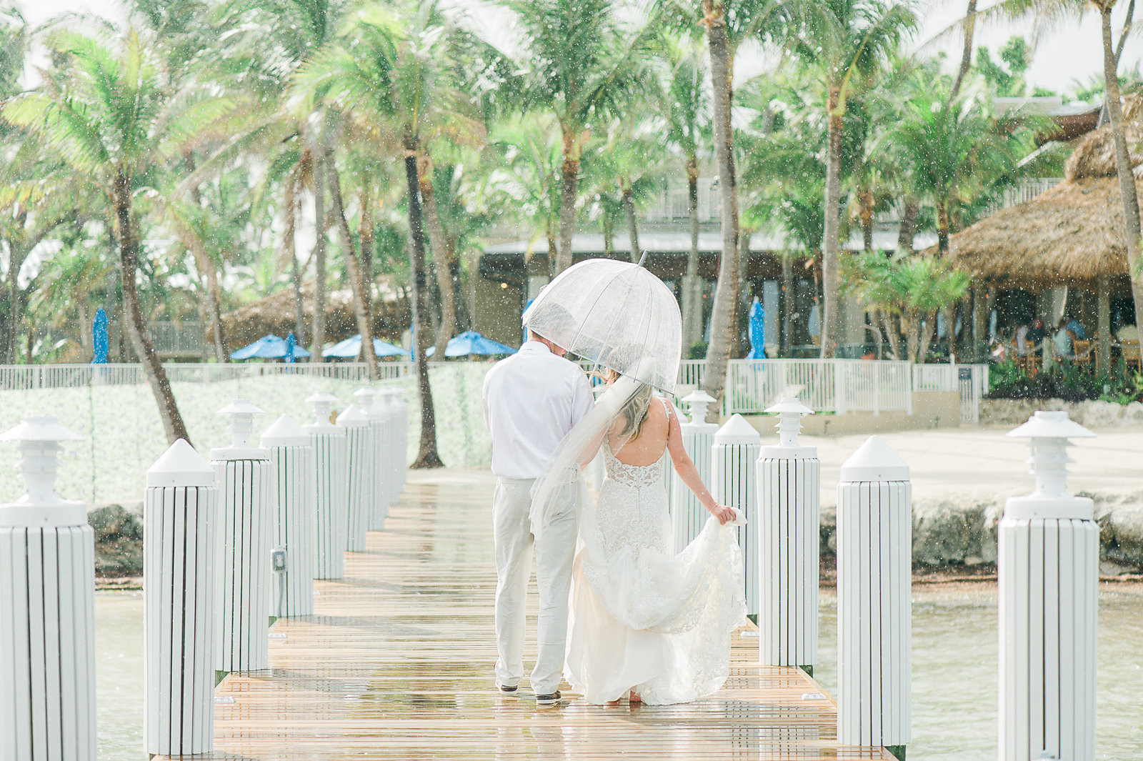 Couple on Pier in rain - Cheeca Wedding - Palm Beach Wedding Photography by Palm Beach Photography, Inc.