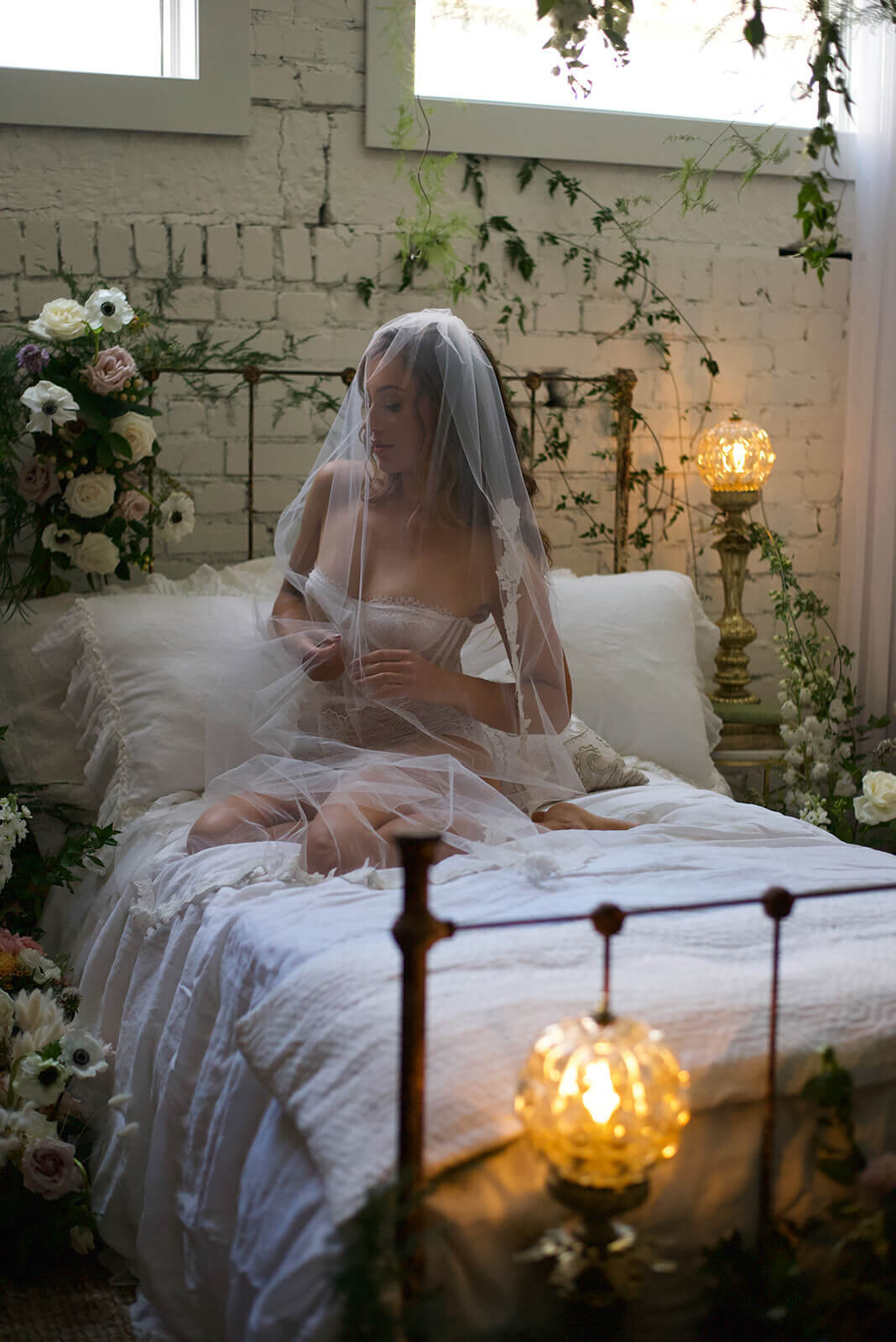 woman on bed in lace lingerie with veil over her head