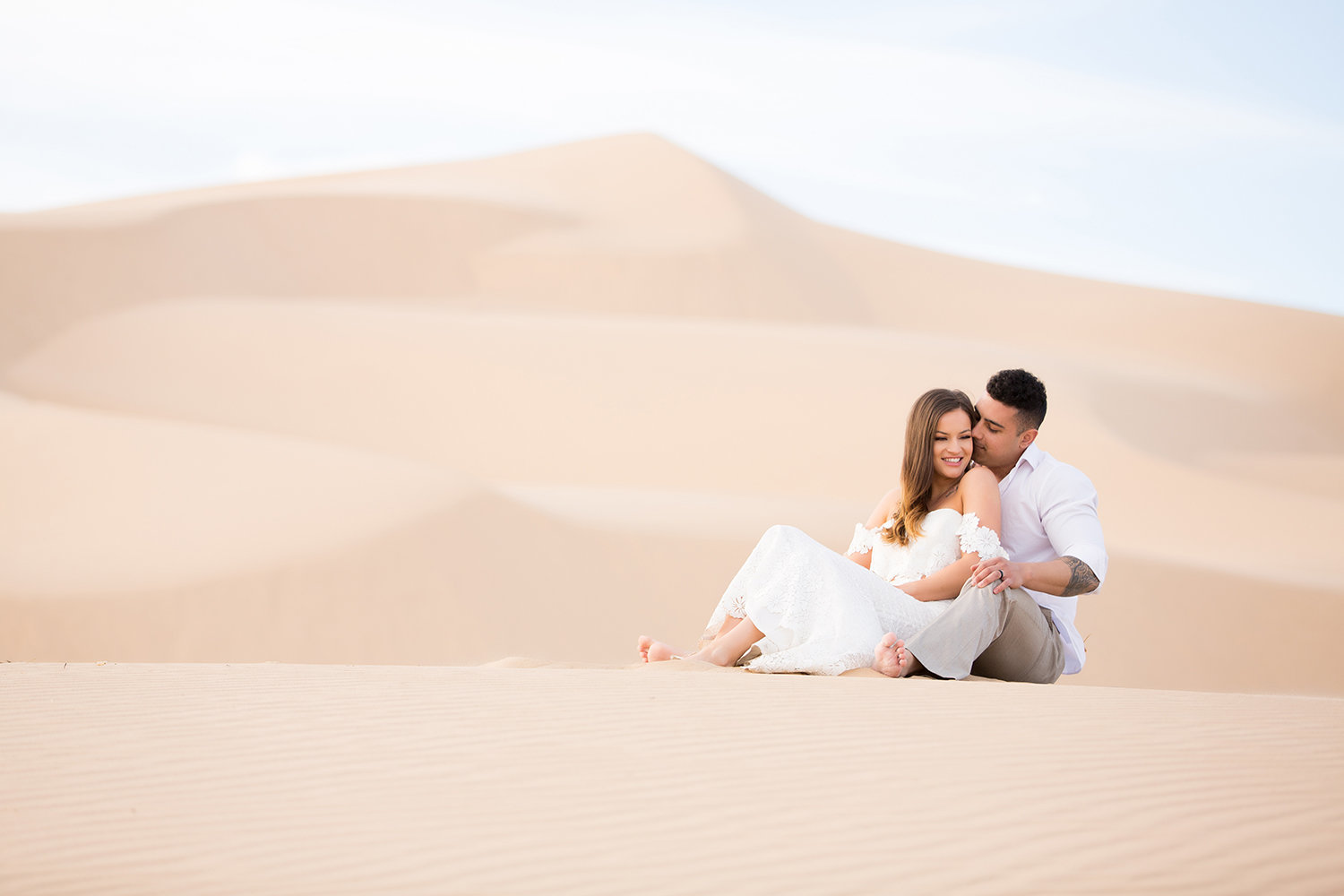 Couple Cuddling in Stunning Glamis Sand Dunes Photo