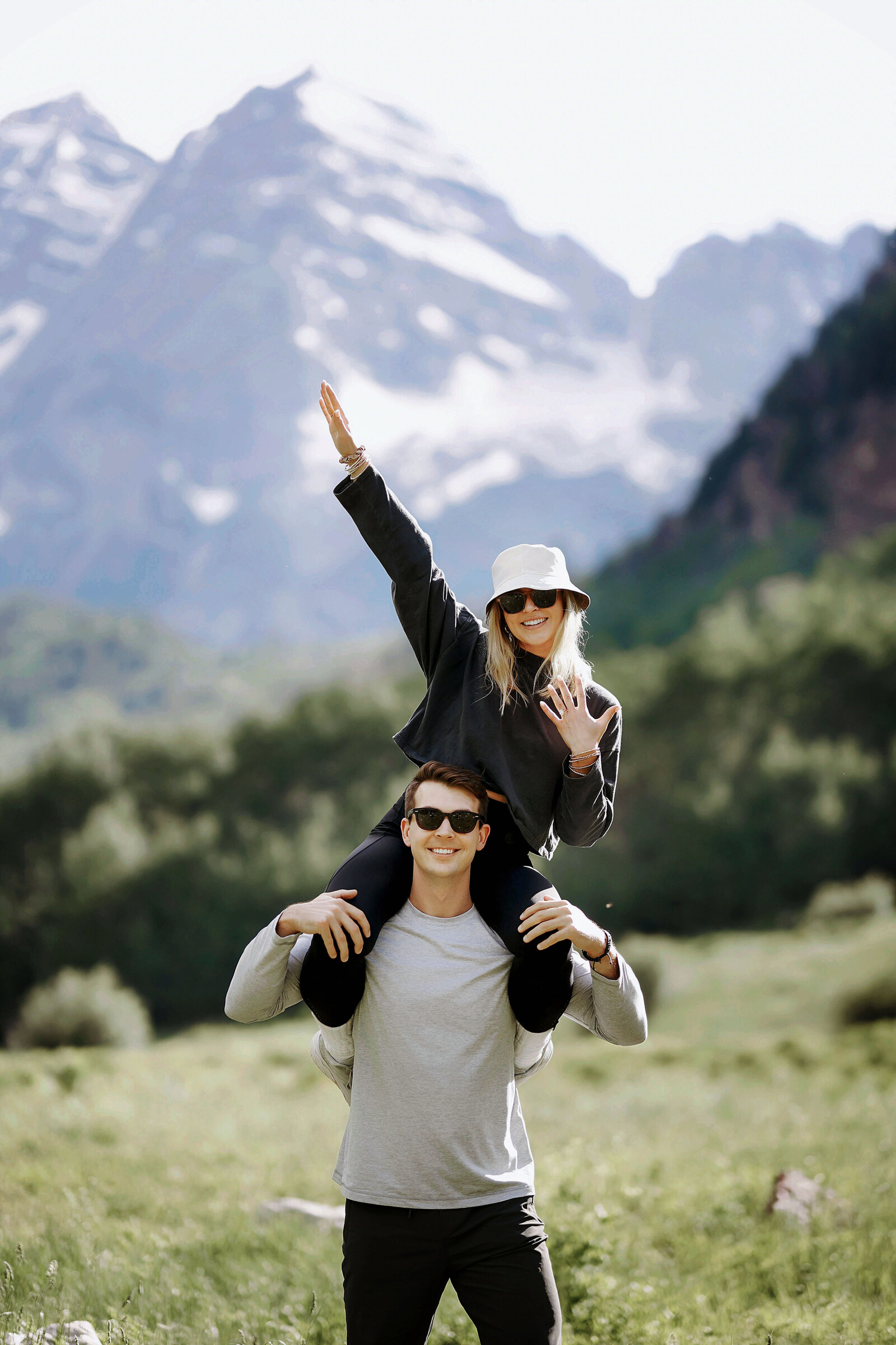 A happy couple celebrates as they just got engaged in front of the Maroon Bells in Aspen, Colorado.