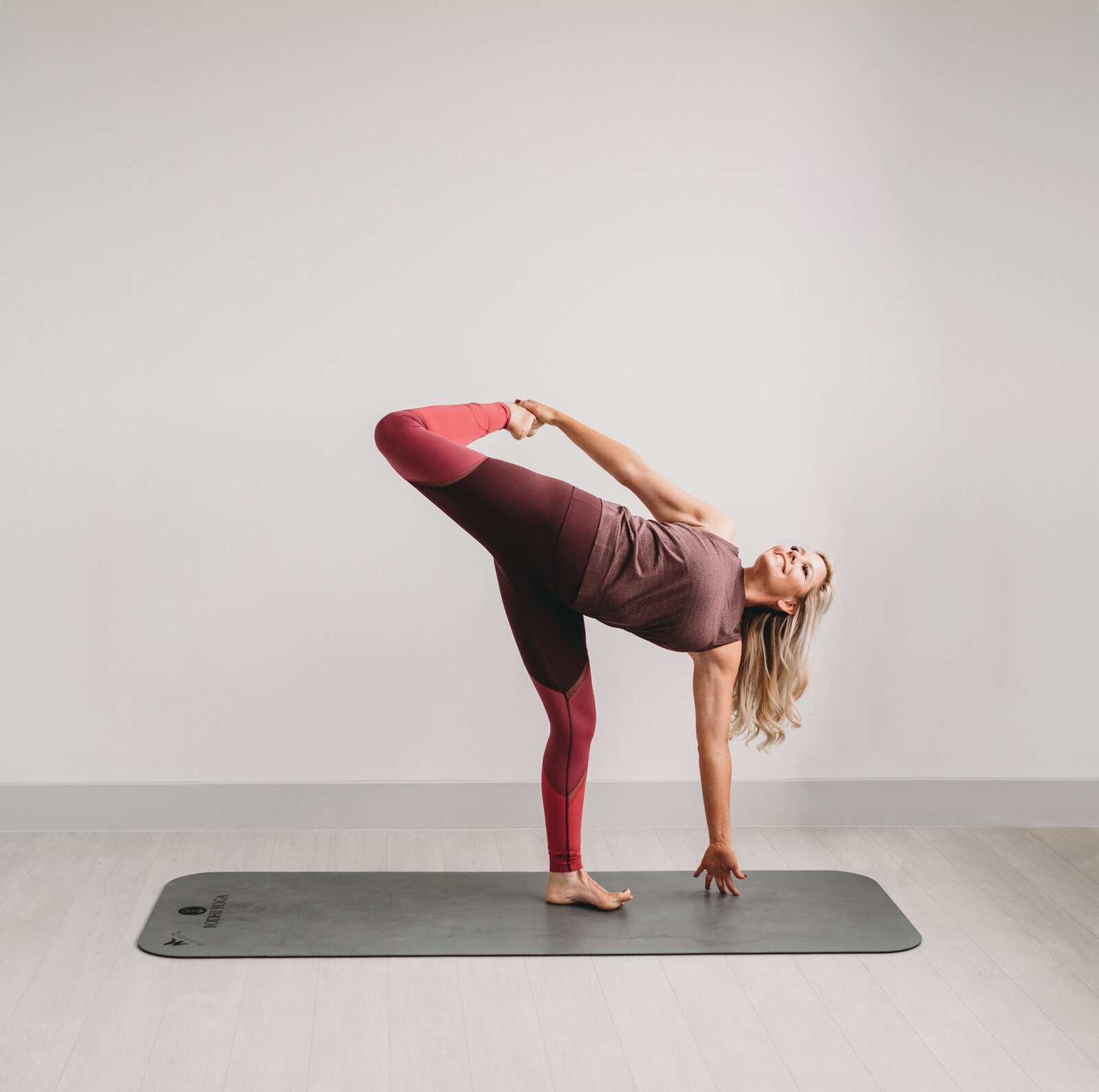 Branding Photographer,  a woman does yoga poses on a mat in an empty room