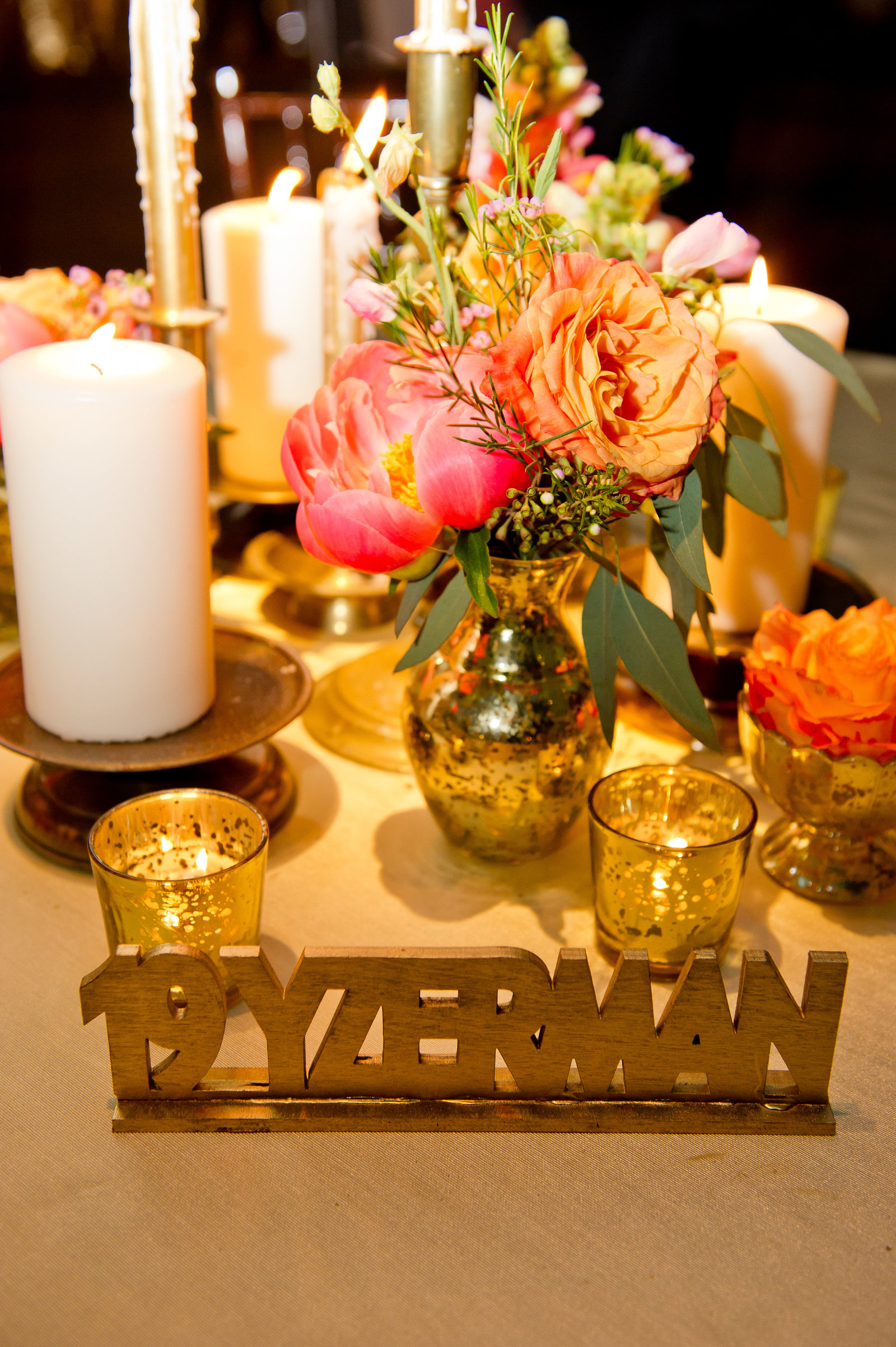 Custom event decor and table names by Ten23design with florals by A Garden Party for Jewish wedding ceremony and reception at Adventure Aquarium