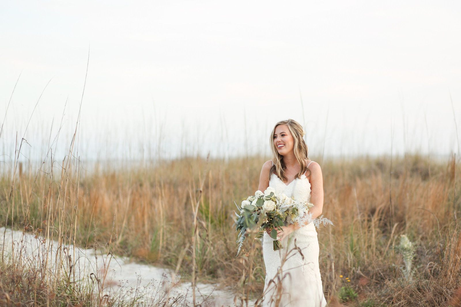 bride standing in grass on beach in hilton head
