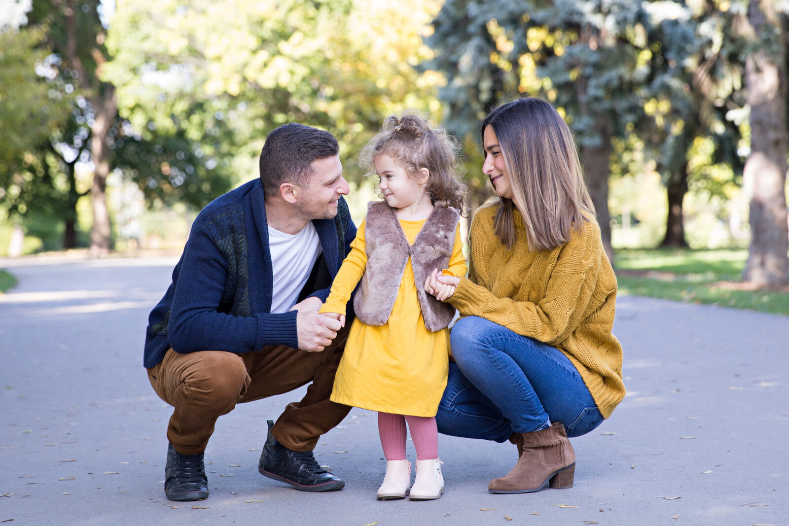 family with little girl dressed in yellow