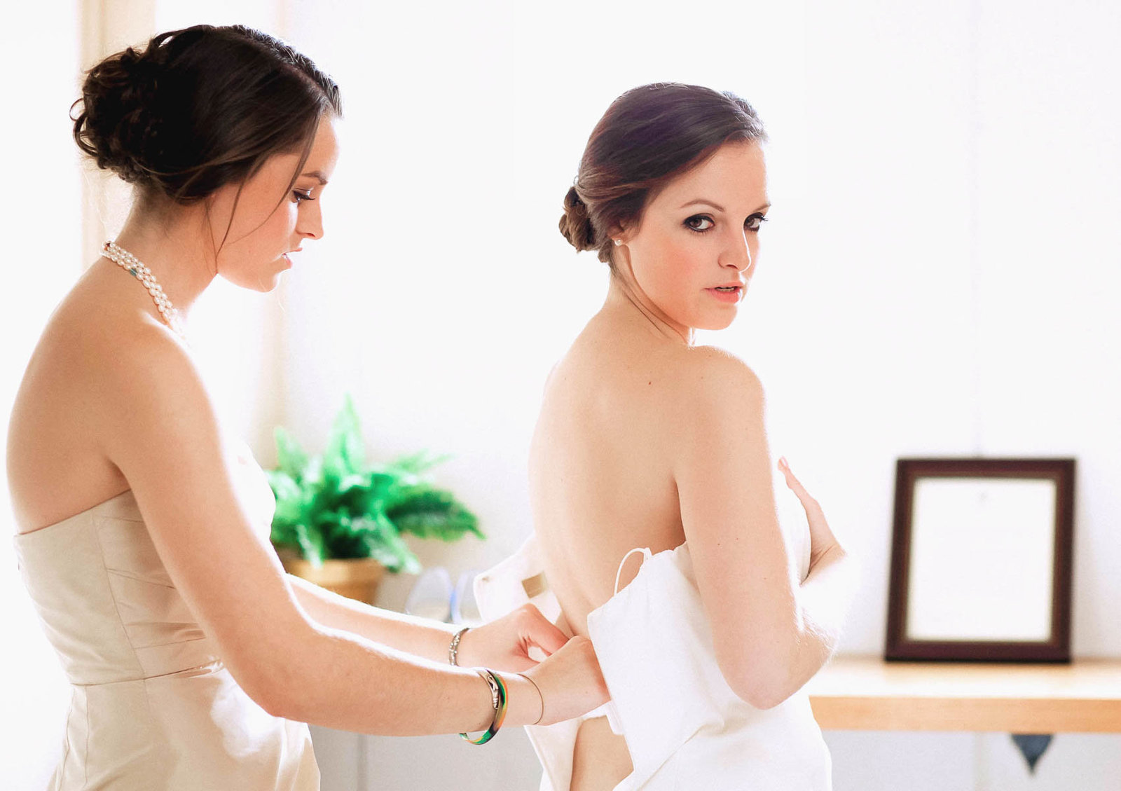 Bride gets into dress, Stonewall Golf Club, Elverson, Pennsylvania. Kate Timbers Photography.