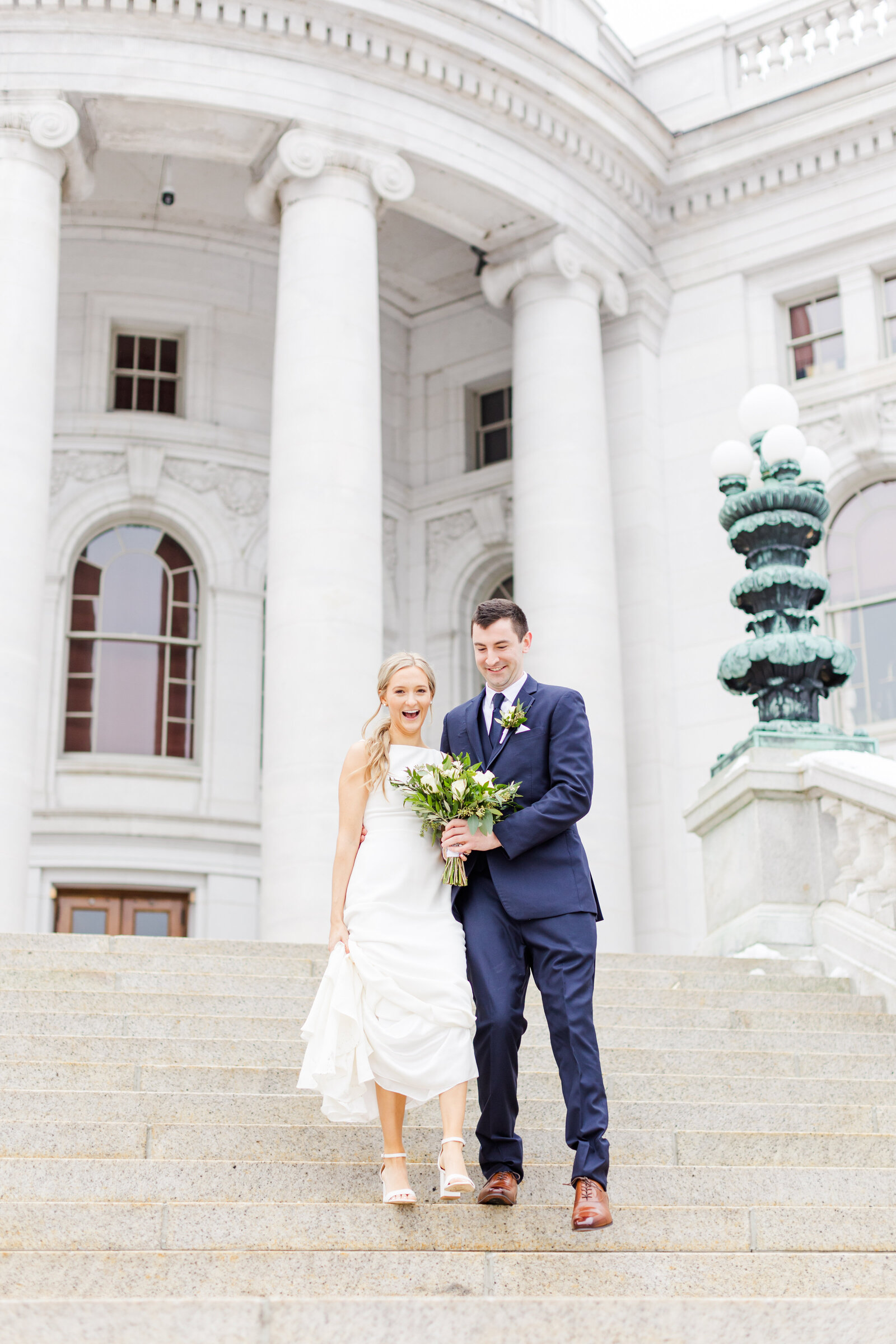 71_bride_and_groom_coming_down_stairs_at_madison_state_capitol