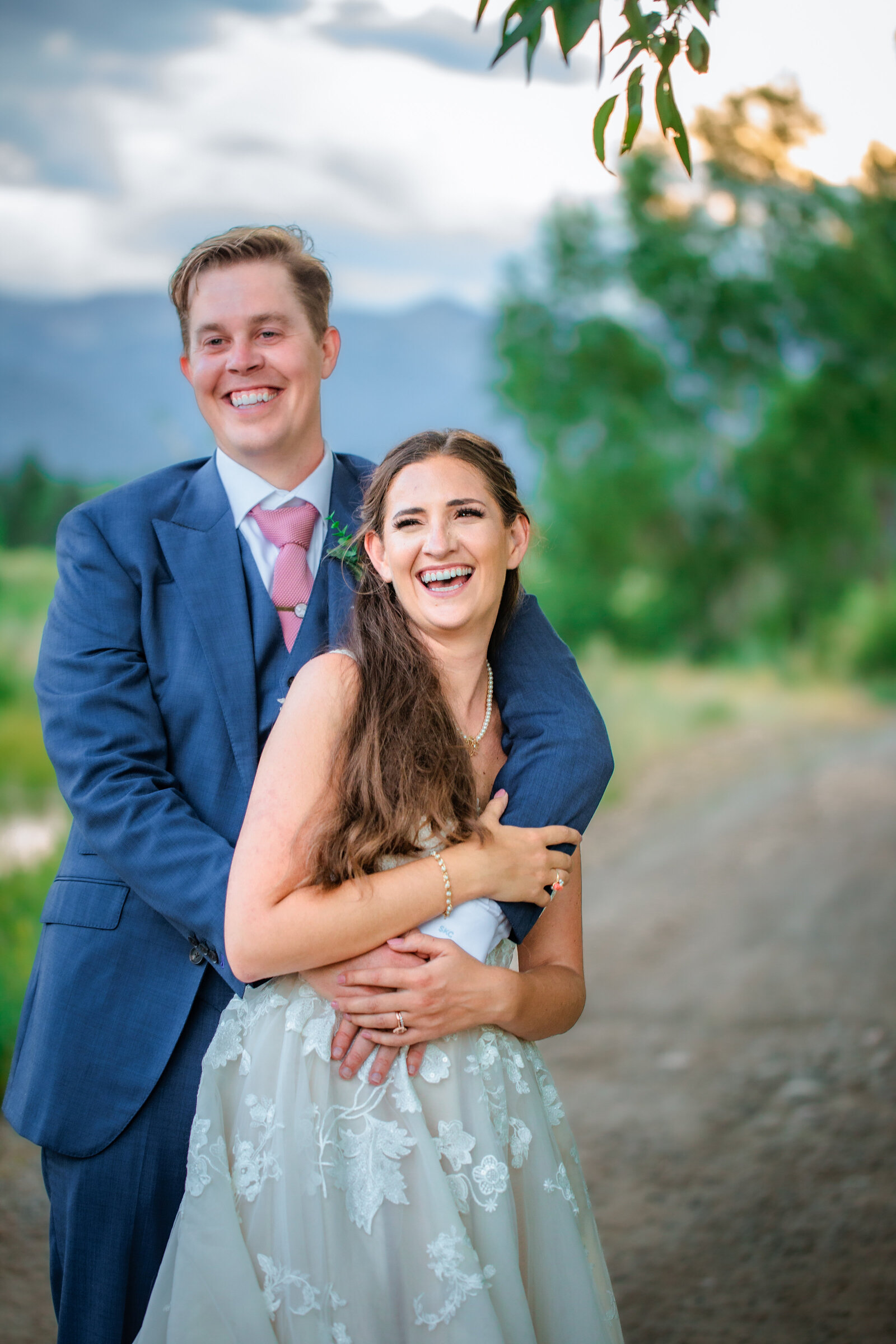 Jackson Hole wedding photographers capture couple laughing during bridal portraits
