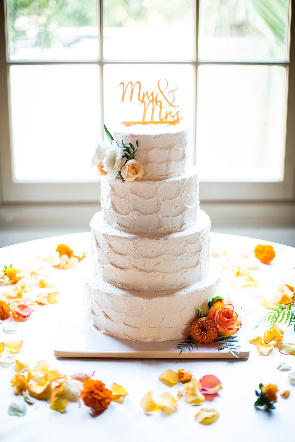 Bright flowers adorn this wedding cake