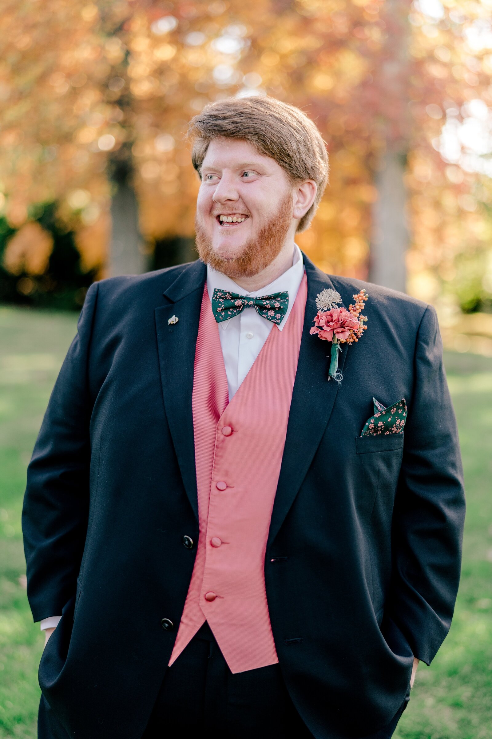 A groom laughs as he poses for a portrait before his wedding in Northern Virginia