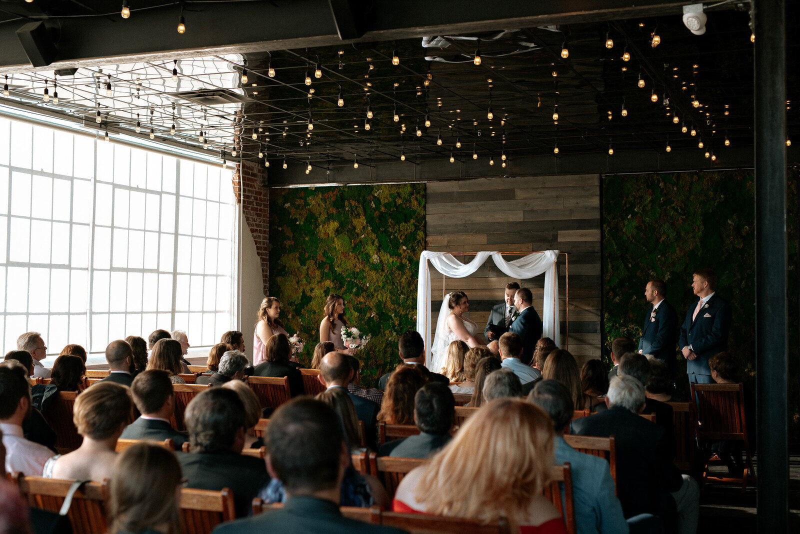 indoor wedding ceremony, photo of bride and groom saying their vows.